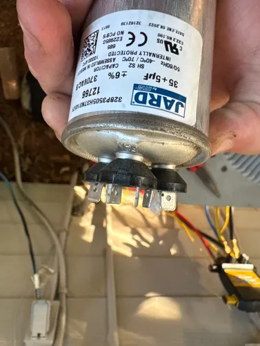 HVAC capacitor inspected during a Leeds heat pump service visit