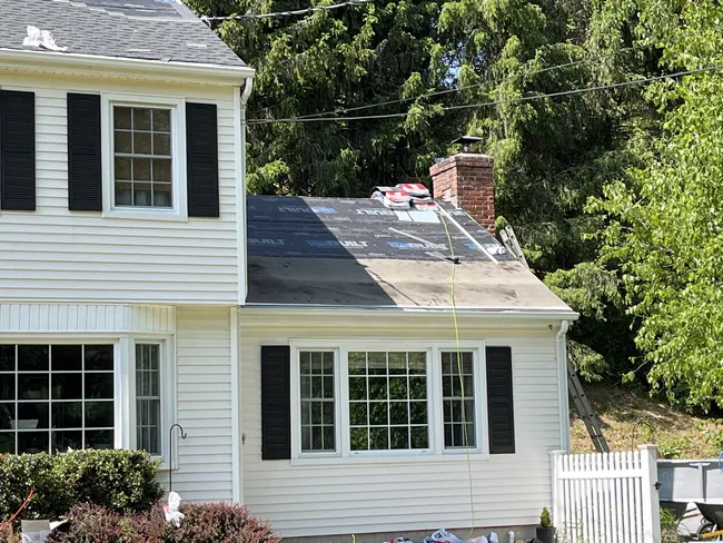 Installed charcoal GAF shingles with durable lead wall flashing for a secure, weather-resistant roof.