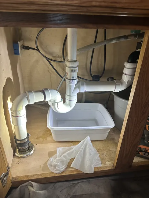 After expertly repairing a broken drain line, the kitchen sink is now restored to optimal function.