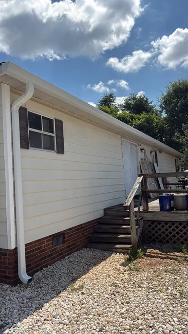 New 6-inch seamless gutters and downspouts were installed, enhancing drainage and durability for a Mooresville home.