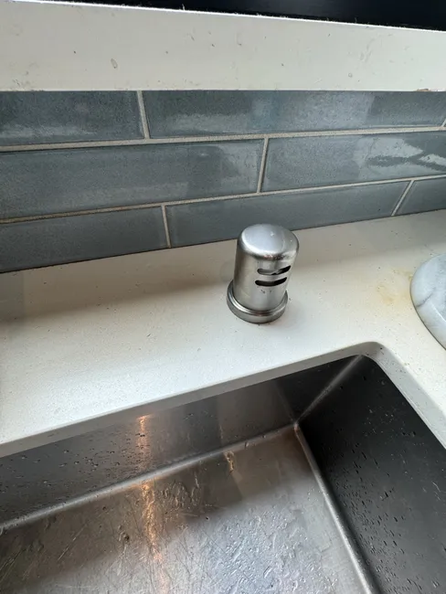 A malfunctioning dishwasher air-gap caused drainage issues. We replaced it, ensuring efficient water flow and peace of mind.