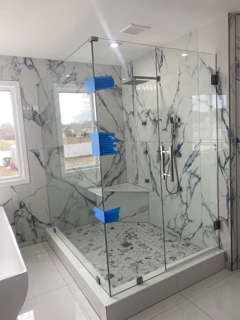Three Panel Frameless Glass Shower Enclosure with Brushed Nickel Hinges and a Square Ladder Handle