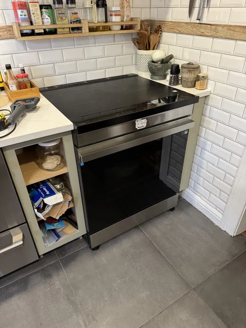 The new range has been installed in its final position and is seamlessly aligned with the wall.