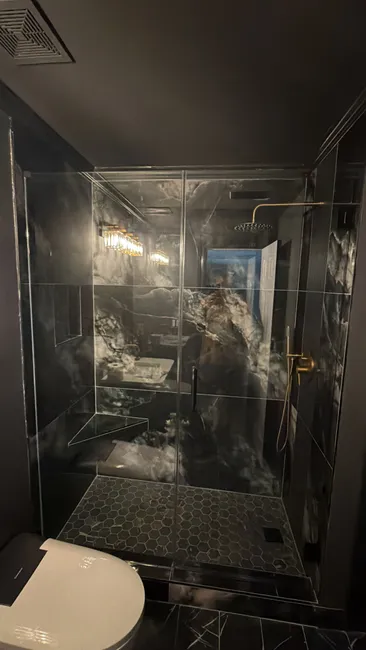 In a blacked-out bathroom, our installation of a clear tempered glass screen provided privacy and style, enhancing the space while ensuring safety.