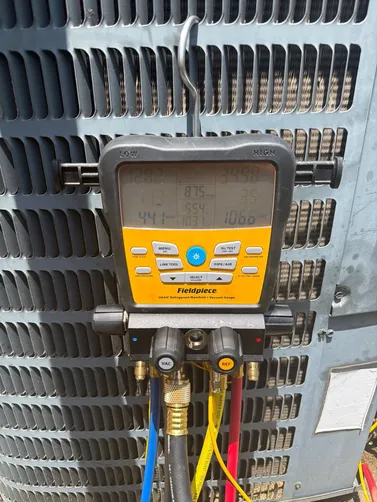 Refrigerant gauges connected during a Helena air conditioning service visit