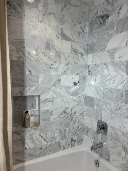We upgraded the old shower valve to a new Moen Posi-Temp, ensuring consistent temperature and a stylish look.
