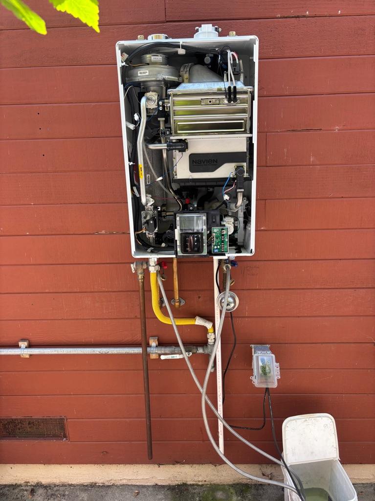 Tankless water heater being flushed to remove scale buildup in Costa Mesa