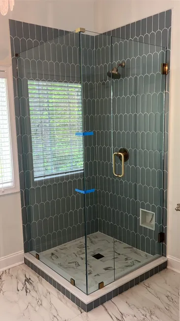 A custom 3-panel swing door shower enclosure was installed, elevating the first-floor master bathroom's style and function.