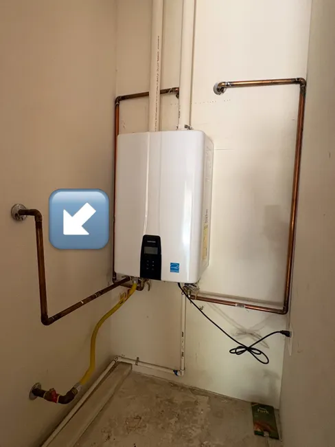 During a remodel, we corrected the T&P line of a tankless water heater for optimal drainage and safety.