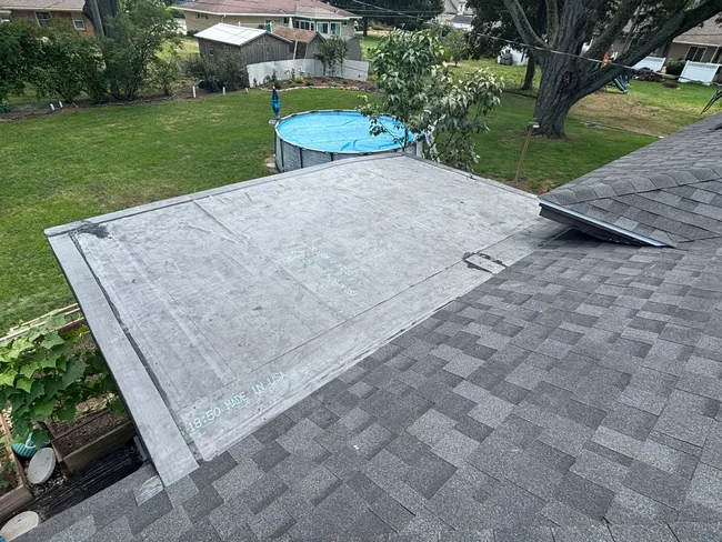 We replaced the worn shingle roof, added new decking, and installed a durable flat roof to ensure lasting protection for this home.