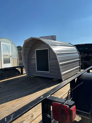 photo at Carthage, TX on Dec 11, 2025: 4x4 Metal dog house with solid floor, treated 2x4 skids, awning on front, XL cut outPewter Gray wi