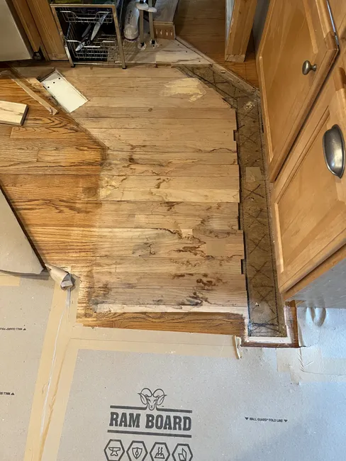 Refinished the kitchen floor and replaced hardwood, creating a seamless, beautiful transition.