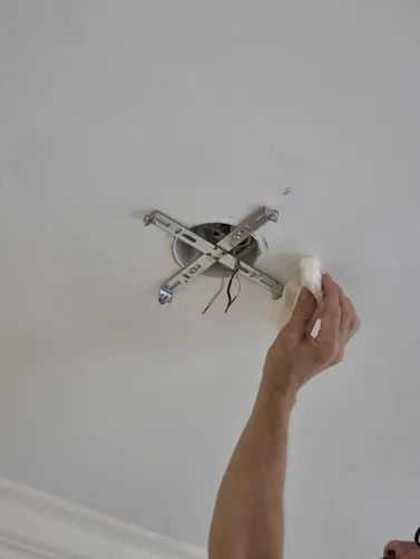 Replace light fixture with fan using exisitng wiring. Customer requested to use old light fixture in hallway in replace of recessed can light. Hallway light was not replaced. Canned light was self-tapped into metal bearings in ceiling.