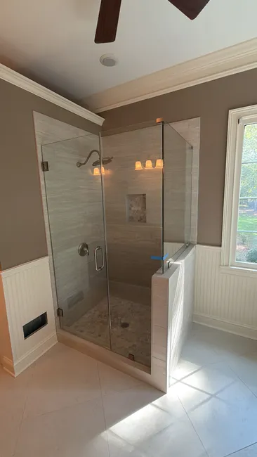 We installed a sleek, 3-panel glass shower door with brushed nickel accents, enhancing both style and functionality.